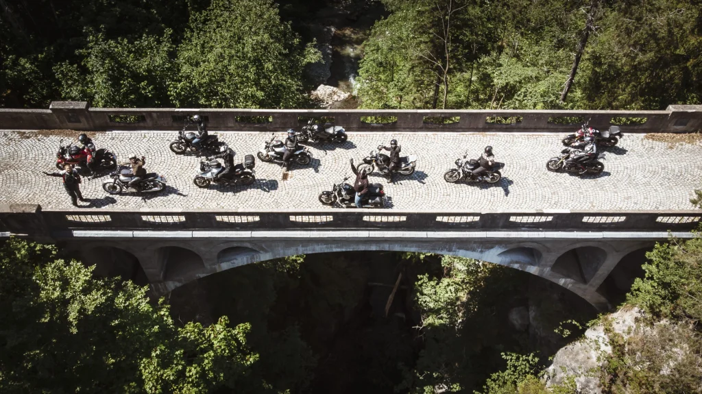Motorradgruppe auf Steinbrücke im Grünen nahe Hohe Tauern Nationalpark